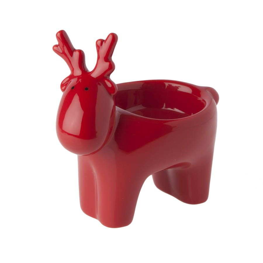 red and white reindeer tea light holder by the christmas home