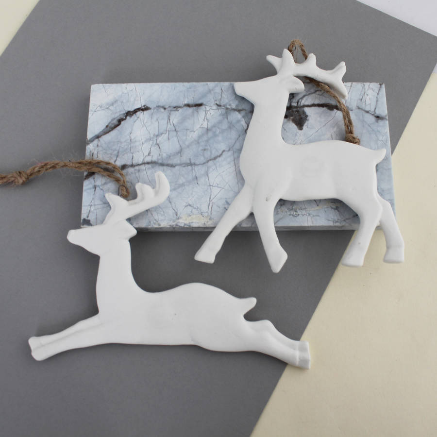 pair of white ceramic reindeer by posh totty designs interiors