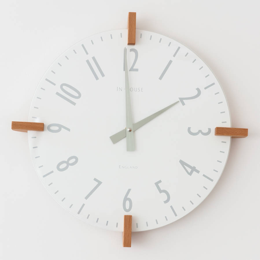 dark grey peg wall clock by cottage in the hills