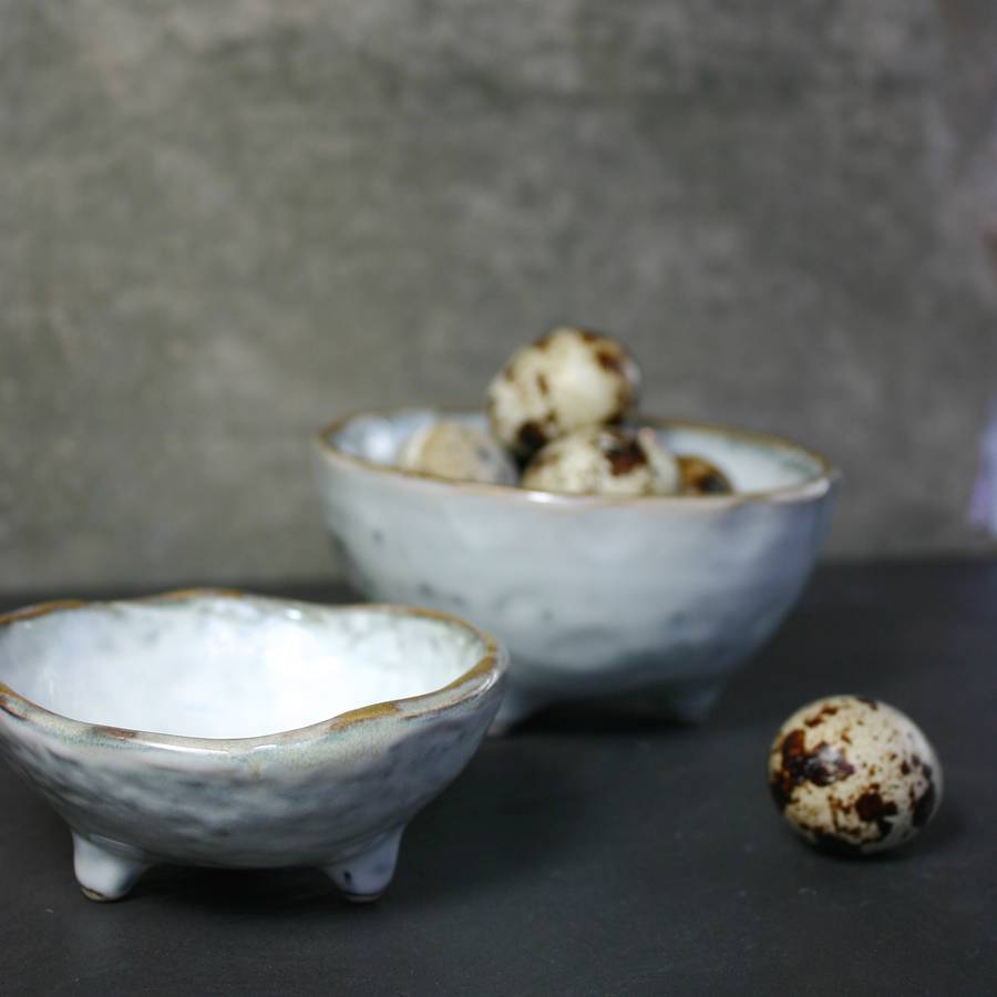 two handmade bowls with feet by the living lounge