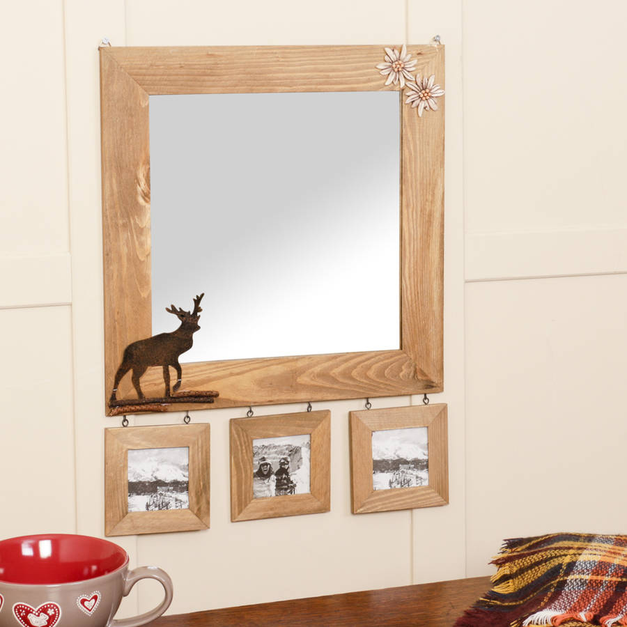 wooden wall mirror with deer detail and photo frames by ...