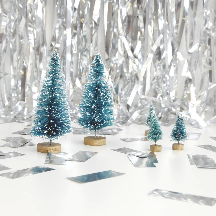small decorative christmas trees by peach blossom