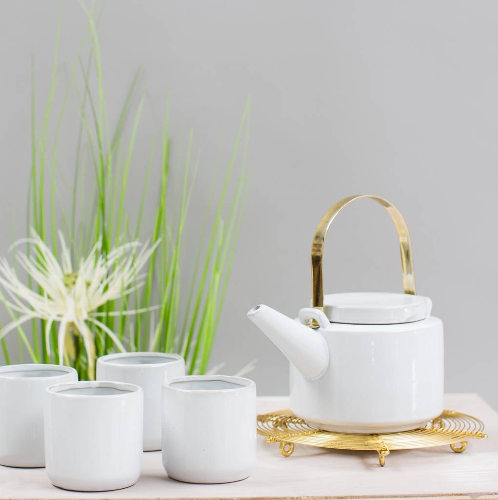 gold handled tea pot and cup set by the forest & co