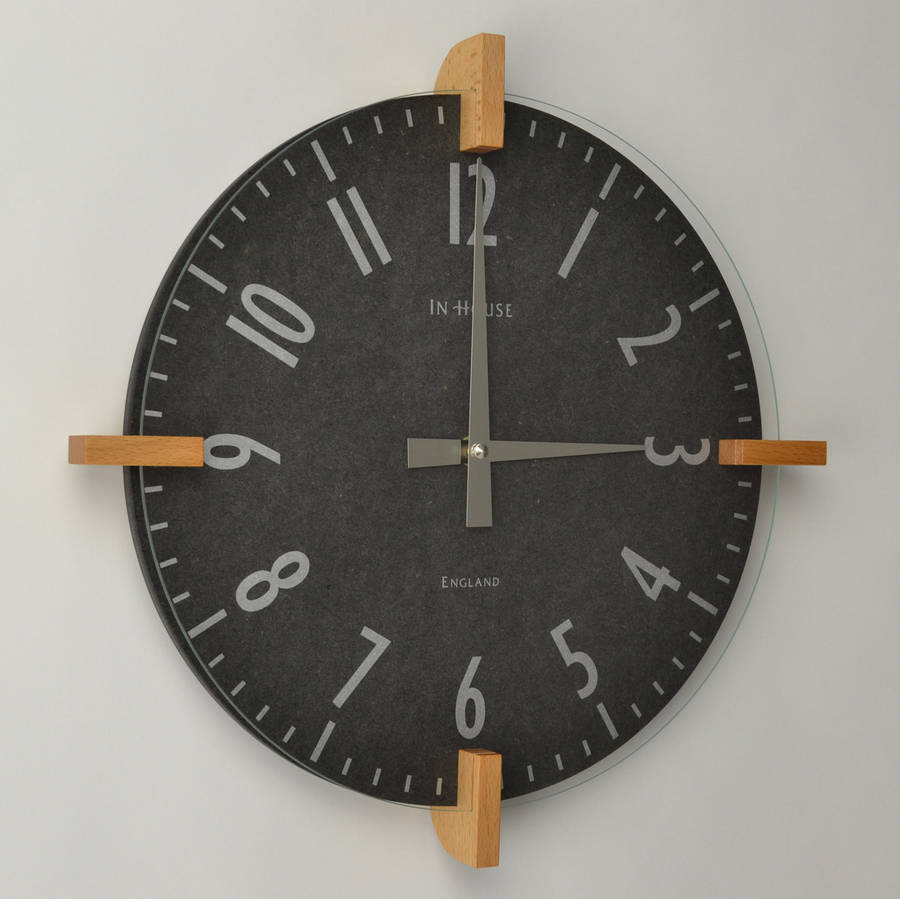 dark grey peg wall clock by cottage in the hills