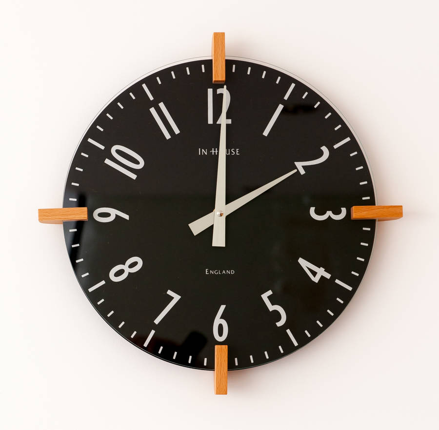 dark grey peg wall clock by cottage in the hills