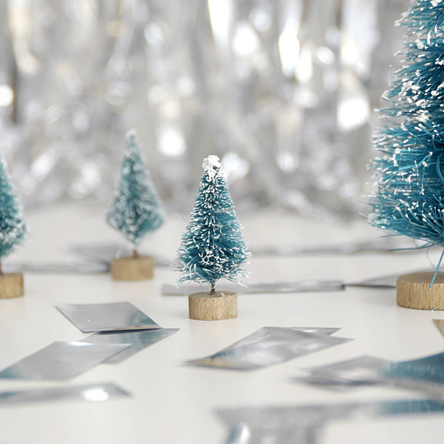 small decorative christmas trees by peach blossom