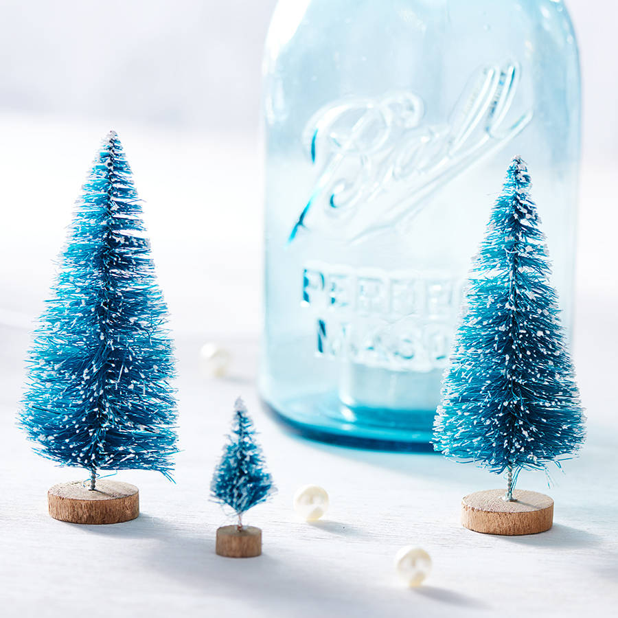 small decorative christmas trees by peach blossom