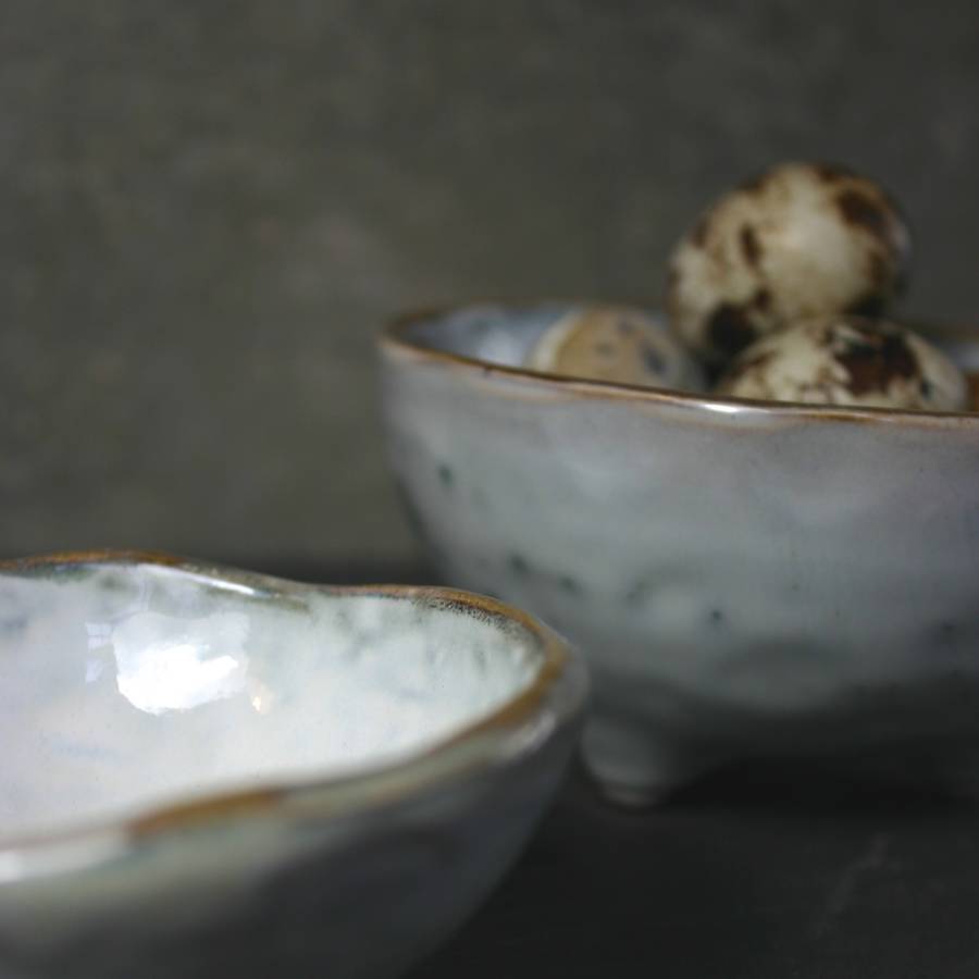two handmade bowls with feet by the living lounge