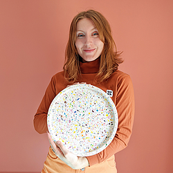 Lucy, Hey Kiddo Co, holding an XL terrazzo cocktail tray