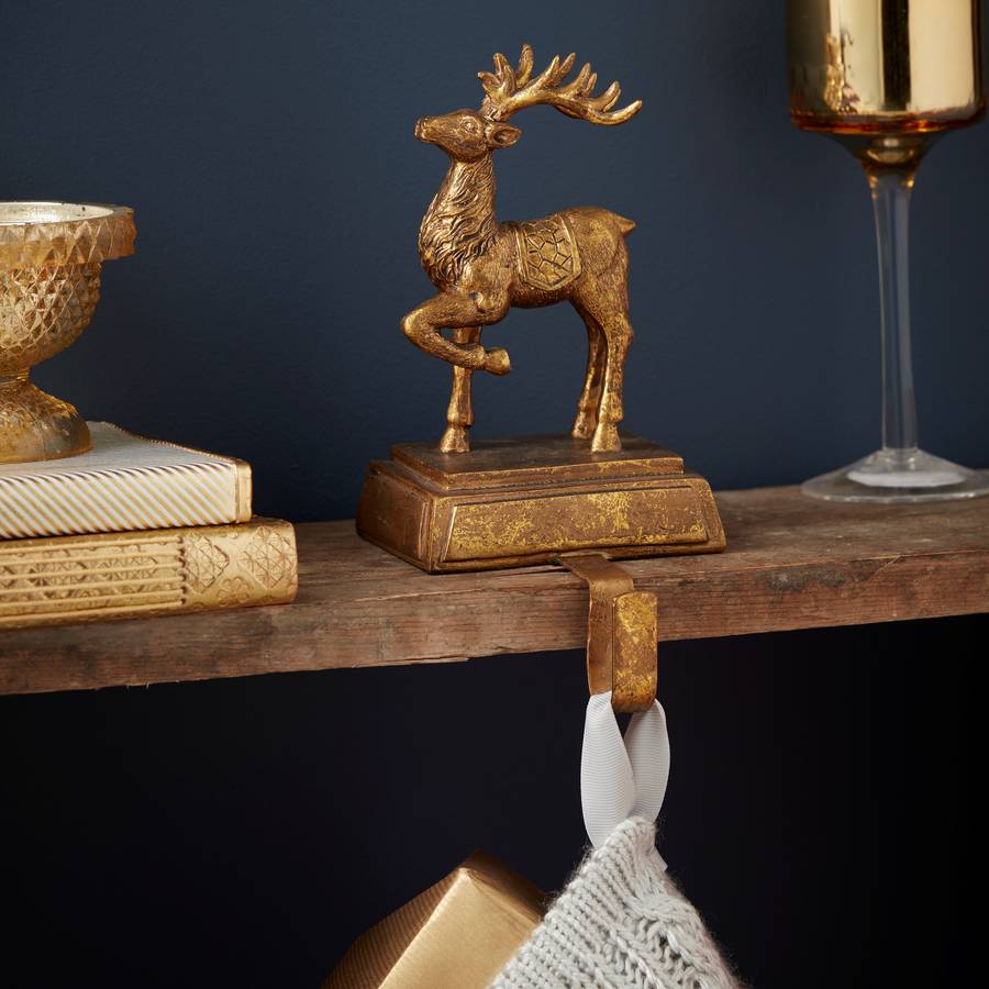 gold reindeer stocking hanger by the christmas home