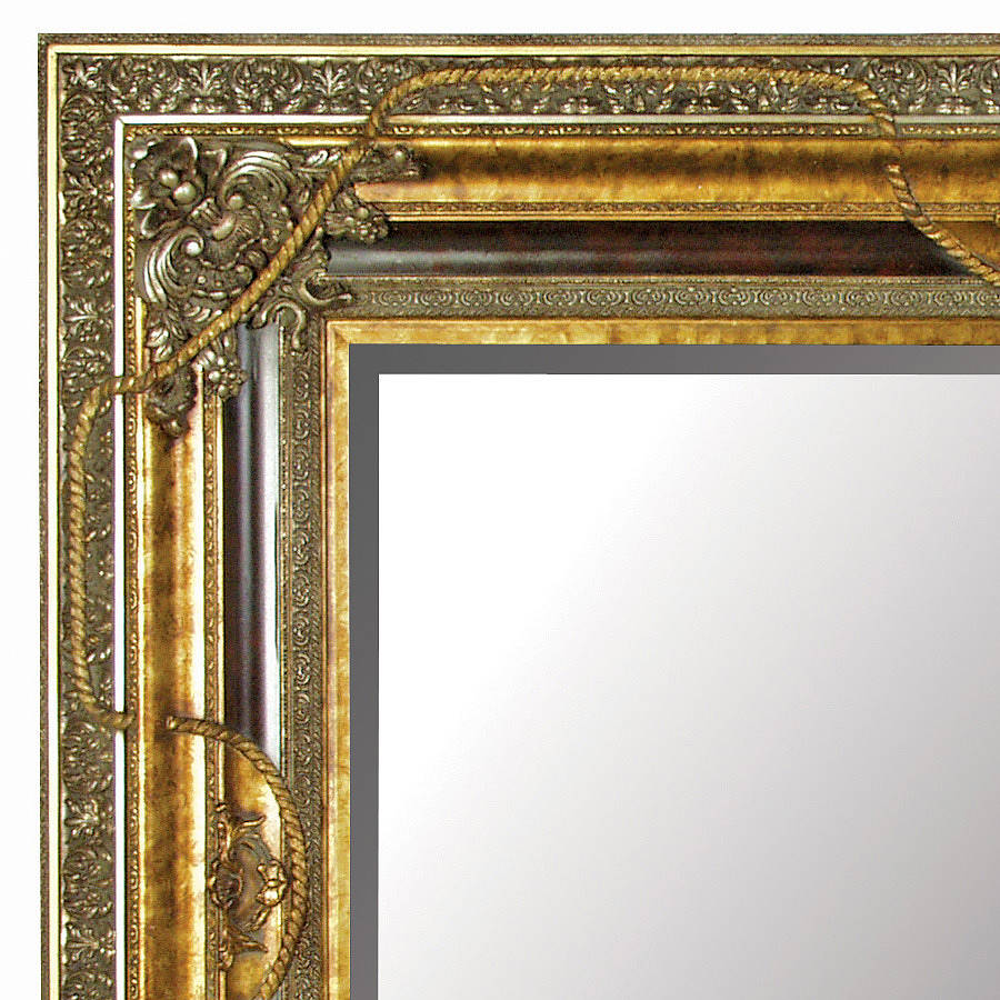 large gold mirror with black details by out there interiors