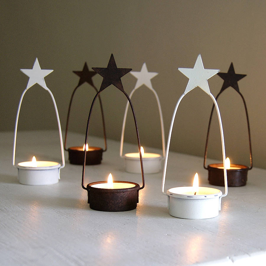 set of two star tea light holders by red lilly