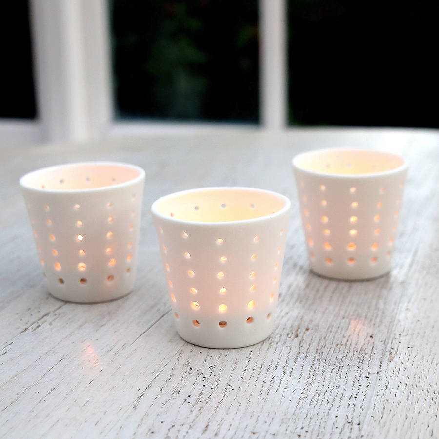 white ceramic tea light holder by red lilly