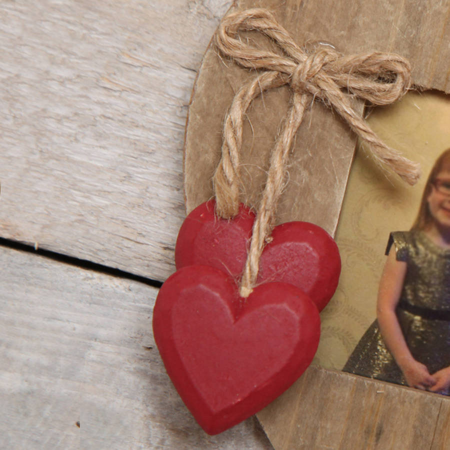 wooden love heart hanging photo frame by red berry apple