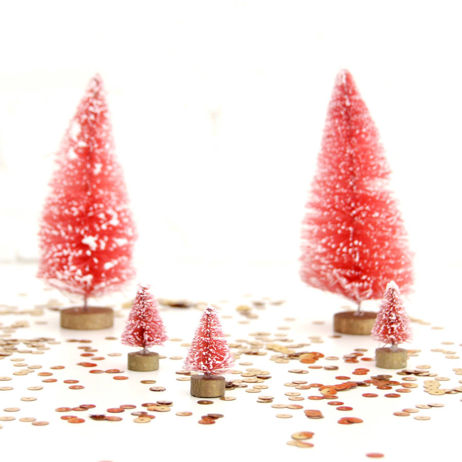 small decorative christmas trees by peach blossom
