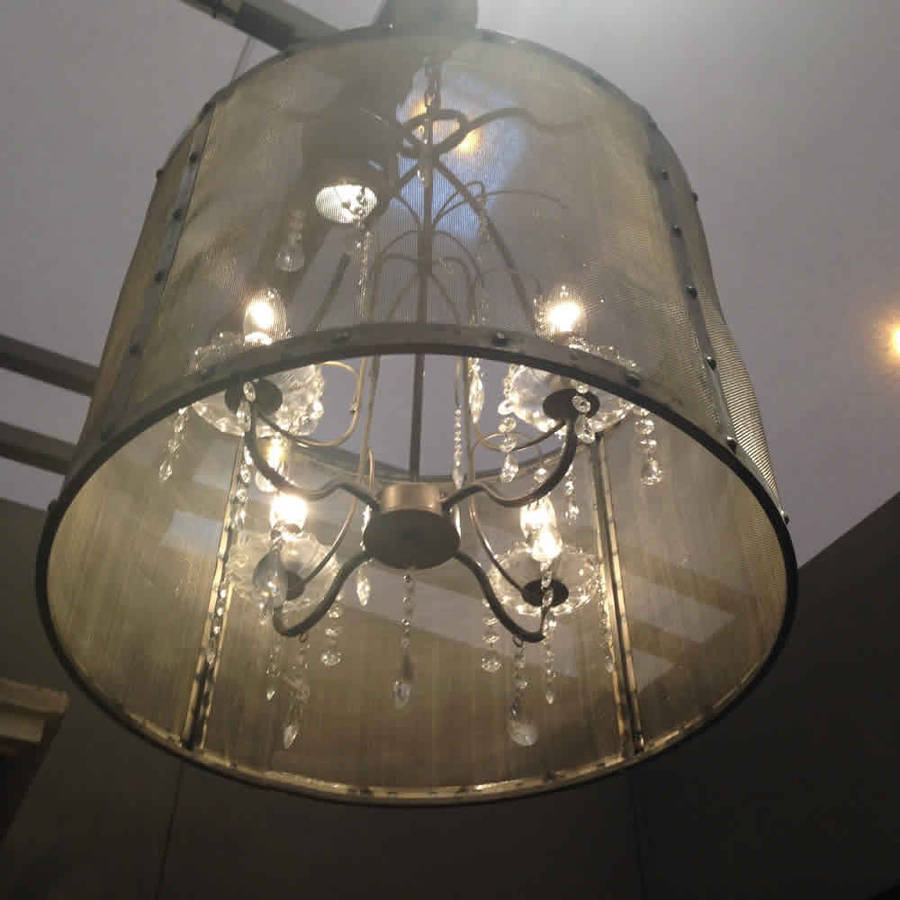 riveted metal mesh round chandelier with glass droplets by cowshed
