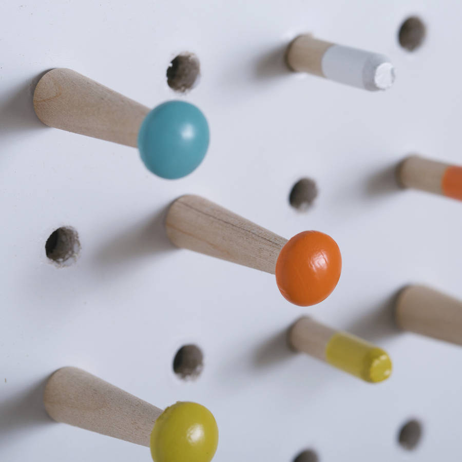 white pegboard with wooden pegs, medium by block design