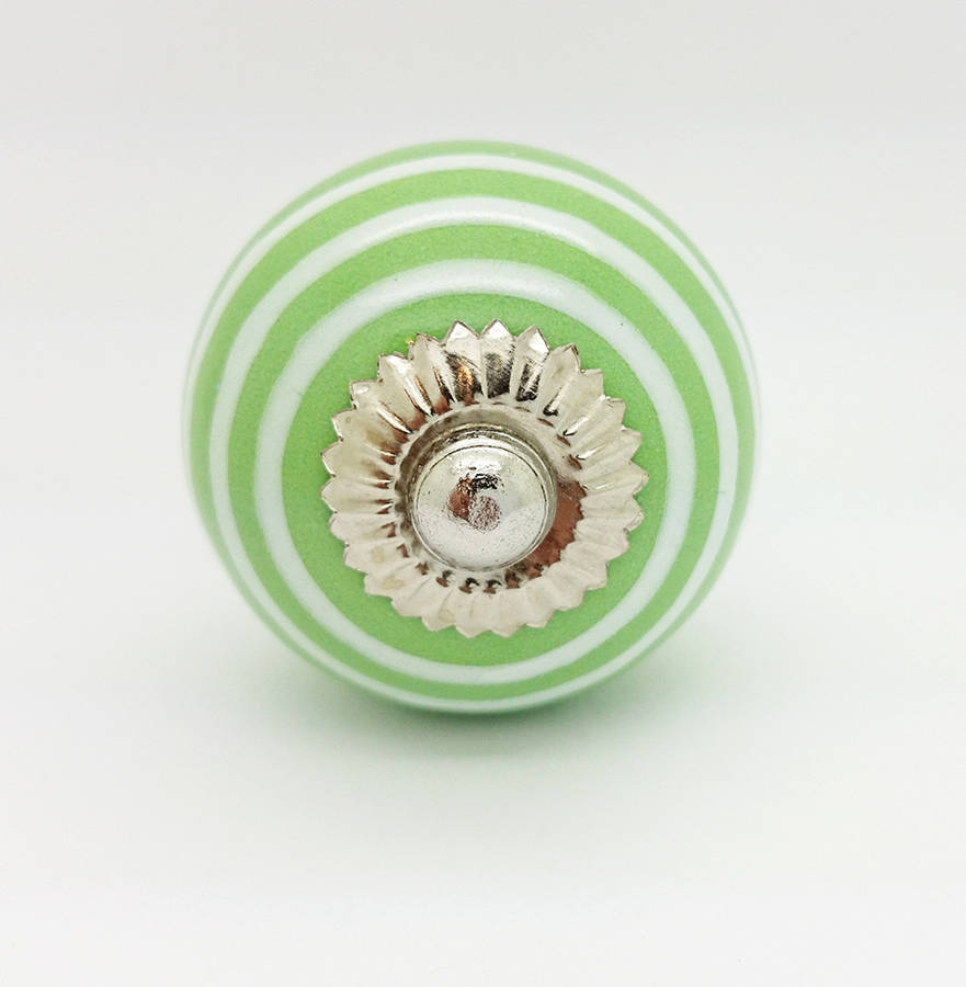 white striped on light green cupboard door knob handle by ceramic door