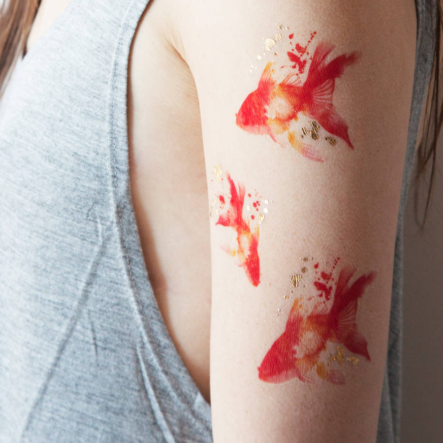 Red and black goldfish arm tattoo