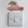 Red Car Carrying A Christmas Tree Light Decoration, thumbnail 2 of 2