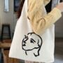 White Canvas Artist Face Illustration Shoulder Tote Bag, thumbnail 2 of 8
