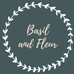 Basil and Fleur main company logo. Pink text with white leaf loop on teal background.
