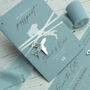 Dusty Blue Passport Invitation With Acrylic Plane Charms For Destination Wedding, thumbnail 1 of 9