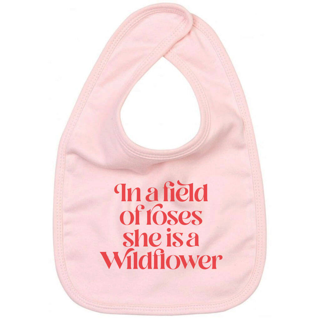 In A Field Of Roses She Is A Wildflower Slogan Baby Bib, 1 of 2