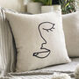 Embroidered Face Art Linen Cushion, thumbnail 1 of 5