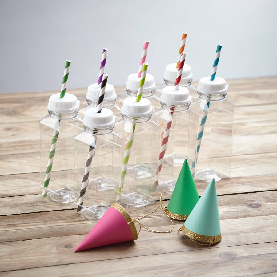 children's milk bottles by pink biscuits