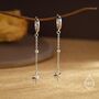 Sterling Silver Dangling Starburst Huggie Hoop Earrings, thumbnail 1 of 11