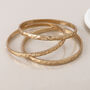 Set Of Three Gold Plated Hammered Bangle Bracelet Stack, thumbnail 4 of 5
