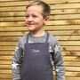Children's Linen Charcoal Embroidered Apron, thumbnail 1 of 3