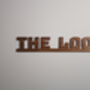 The Loo Sign: Walnut Wood Door Topper With Adhesive Dots, thumbnail 5 of 7