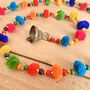 String Of Rainbow Pom Pom's With Brass Bell, thumbnail 4 of 5