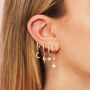 Romilly Crystal Gold Droplet Star Huggie Earrings, thumbnail 2 of 2