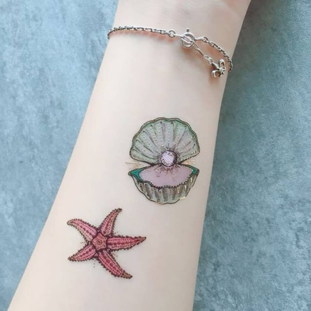 Minimalist anchor, sun, starfish and palm tree tattoo.