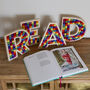 ‘Read’ Plywood And Wool Pom Pom Letters Decoration, thumbnail 1 of 6