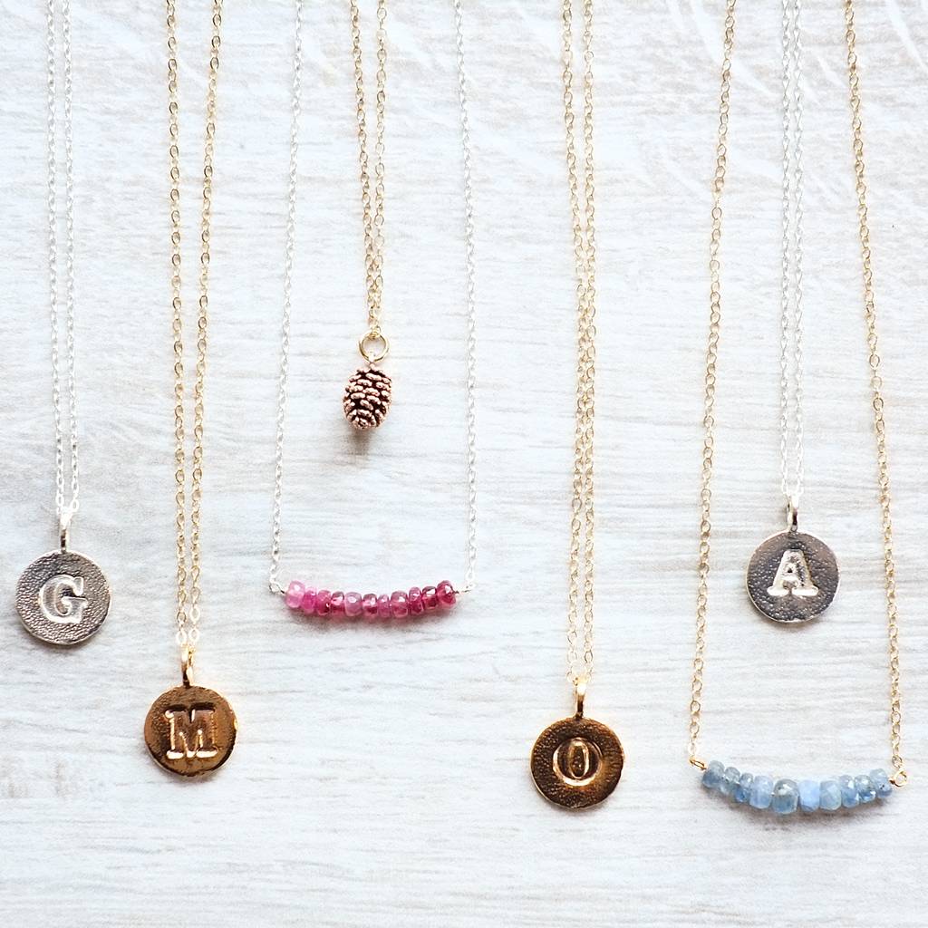 handmade gold embossed letter necklace by gracie collins