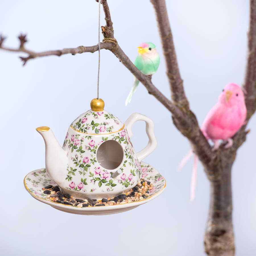 ceramic hanging teapot bird feeder with bird food by thelittleboysroom