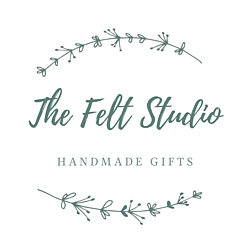 The Felt Studio Logo. Handwritten main text with capital subtext. Floral garland accents sit above and below the main text of the logo.