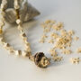 Cream Geometric Beaded Necklace With Natural Spiral Shell Pendant, thumbnail 1 of 5