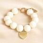 Cream Chunky Beaded Heart Charm Bracelet In Gold, thumbnail 1 of 3