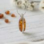 Handmade Cognac Baltic Amber Oval Necklace Pendant, Sterling Silver, thumbnail 1 of 3