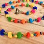 String Of Rainbow Pom Pom's With Brass Bell, thumbnail 3 of 5