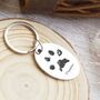 Stainless Steel Personalised Oval Keyring With Paw Prints, thumbnail 1 of 6