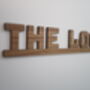 The Loo Sign: Walnut Wood Door Topper With Adhesive Dots, thumbnail 6 of 7