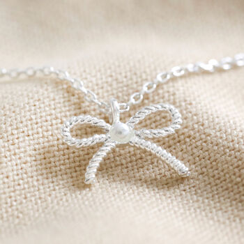 Tiny Pearl Bow Pendant Necklace, 7 of 9