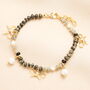 Semi Precious Black Beaded Bow Charm Bracelet In Gold, thumbnail 1 of 2