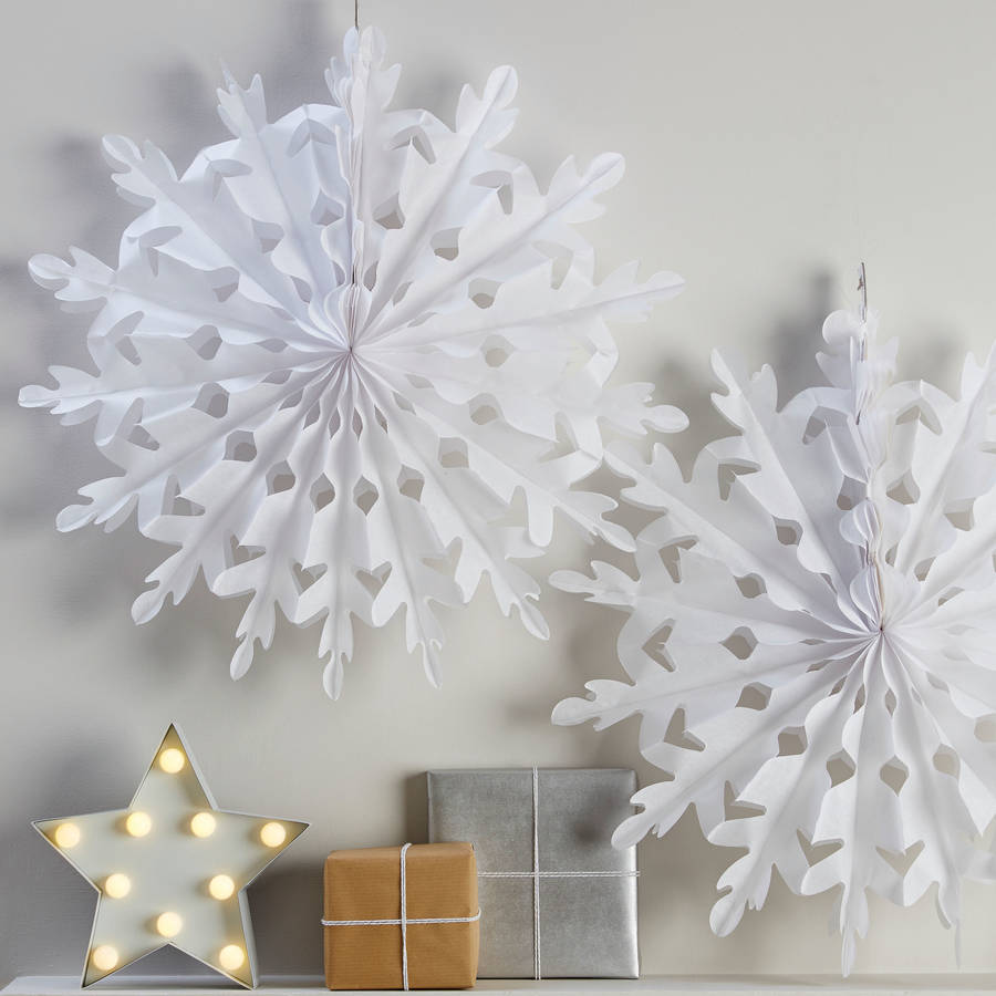 Two white giant hanging christmas snowflake decorations by 